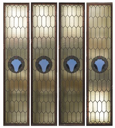 Gruppo di quattro vetrate con vetri policromi legati al pimbo (cm 210x45)...