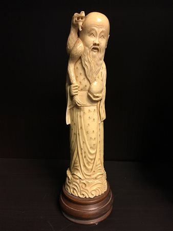 Shoulao in avorio con bastone e pesca, base in legno (h. cm 25)Cina, sec. XX...