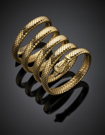 Bracciale in oro giallo elastico a guisa di serpente con paste vitree rosse...