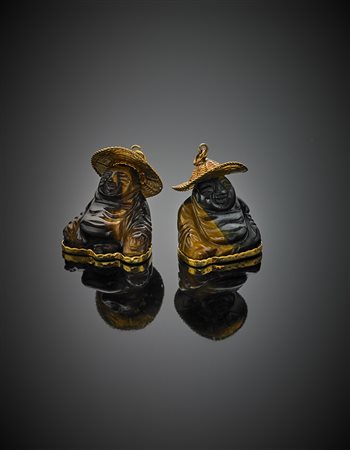 Due pendenti in oro giallo 585/1000 con occhio di tigre scolpito a guisa di...