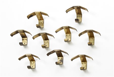 Gruppo di nove appendiabiti in ottone. Italia, anni '50. (cm 11x7x6) (lievi...