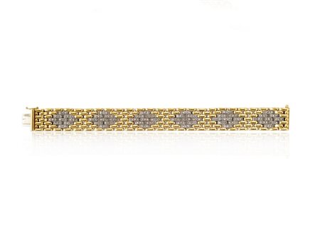BRACCIALE IN ORO GIALLO, ORO BIANCO E DIAMANTI disegnato come un nastro a...