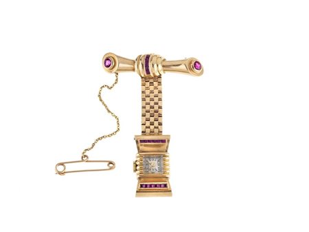 SPILLA-OROLOGIO, FINE ANNI ’40, IN ORO 10 K E RUBINI SINTETICI formata da due...