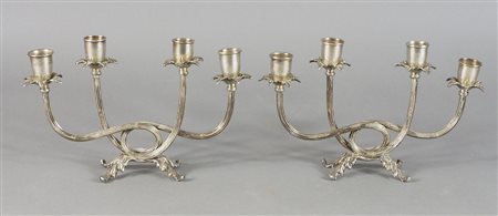 Paio di candelieri in argento a 4 fiamme con corpo attorcigliato. H. cm. 16....