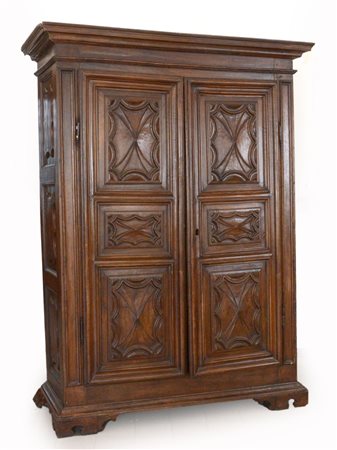 Armadio in legno a due ante pannellate, fronte e fianchi intagliati a...