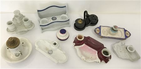 Gruppo di nove calamai in ceramica di differenti fatture e decori (difetti e ma