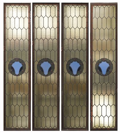 Gruppo di quattro vetrate con vetri policromi legati al pimbo (cm 210x45) (dife