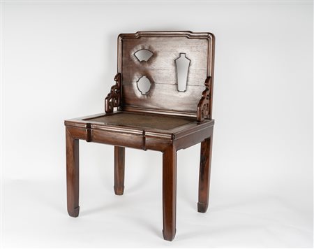 Arte Cinese  A huanghuali chair with seatback carved with the silhouette of antiqueties China, first half 19th century .