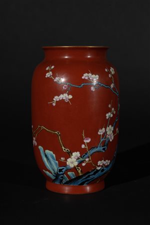 Arte Cinese  A porcelain red ground vase painted with blossoming cherry tree branches and bearing a Qianlong six character seal mark at the base China, 20th century .