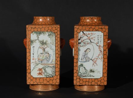 Arte Cinese  A pair of faceted vases painted with figural and vegetal cartouches over salmon tone ground and bearing a red mark at the base China, 20th century .