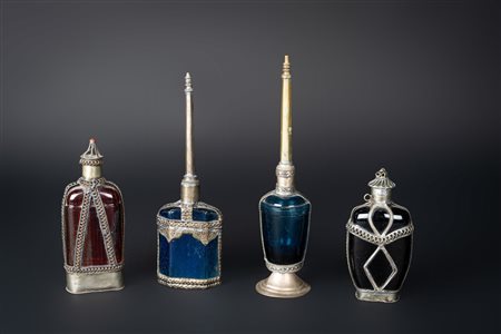 Arte Islamica  A collection of four polychrome glass perfume bottles with silver mount Near East, 19th century .