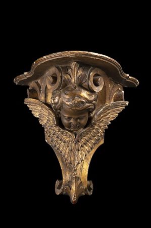Mensola pensile in legno intagliato e dorato a volute e cherubino, piano in leg