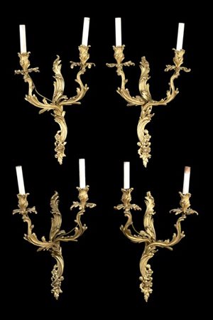 Gruppo di quattro appliques in bronzo dorato a due luci decorate a ramage e fio