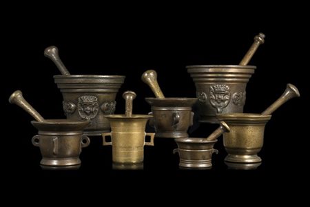 Collezione di sette mortai con pestelli, alcuni decorati in rilievo a festoni.