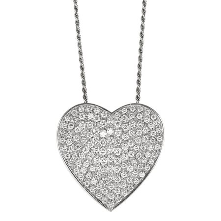 PENDENTE IN ORO BIANCO E DIAMANTI modellato a forma di cuore decorato da pavé...