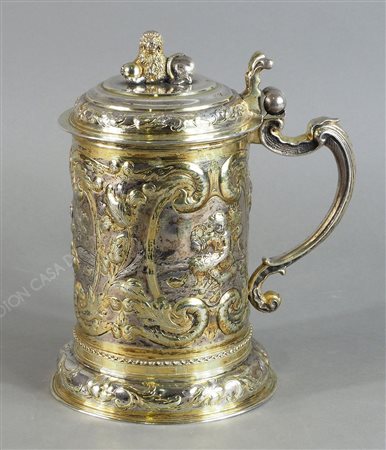 Tankard in argento sbalzato e cesellato con decori floreali e a volute su tre...
