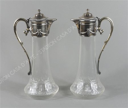 Coppia di brocche in vetro inciso con collo, coperchio e manico in metallo...