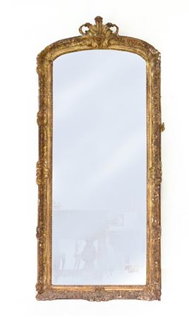 Specchiera in legno intagliato e pastiglia dorata a motivi vegetali e riccioli.