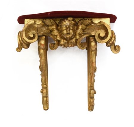 Antico fregio in legno intagliato e dorato a volute e cherubino montato a conso