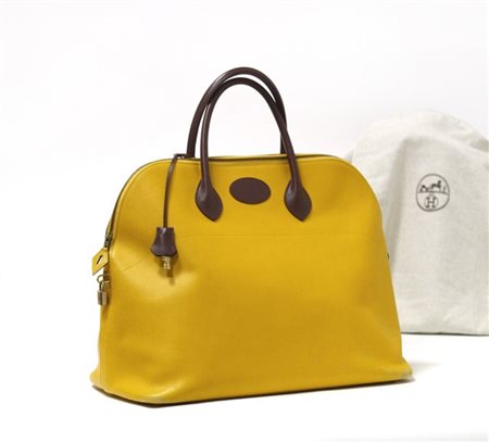 HERMÈS 
Borsa da viaggio Bolide in pelle Courchevel giallo gold, manici marroni