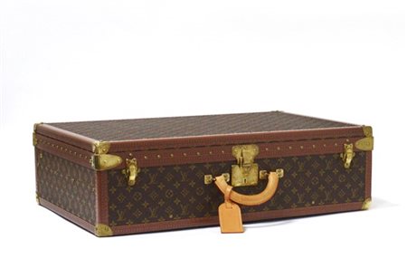 LOUIS VUITTON 
Valigia rigida in tela Monogram bordi color cognac, completa di