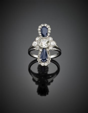 Anello in oro bianco con diamanti per complessivi ct. 1,30 circa e zaffiri, il