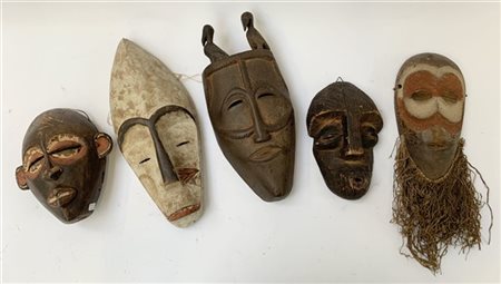 Arte africana, lotto di cinque maschere tribali in legno intagliato, misure div
