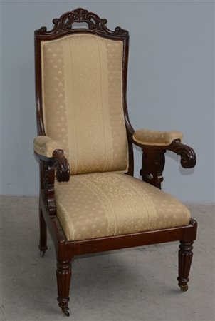Poltrona da riposo in mogano con braccioli e cimasa intagliati, piedi con rotel
