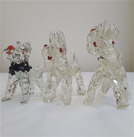Manifattura di Murano Lotto di tre cani in vetro massello incolore. Secolo XX. (