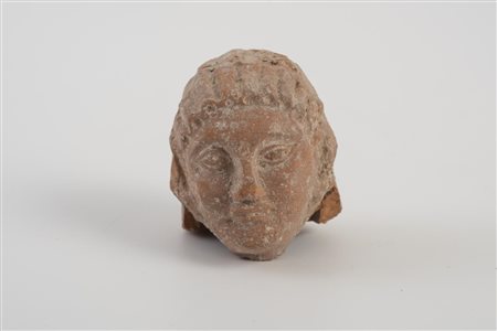 TESTA FITTILE VOTIVA DATAZIONE: VI sec. a.C. MATERIA E TECNICA: impasto beige...