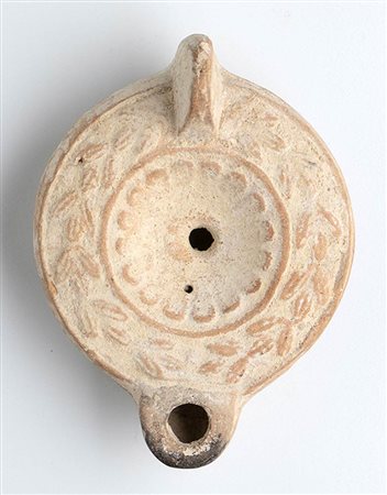 Roman Oil Lamp with Wreath around, 1st - 2nd century AD; height cm 5,5, length cm 12,5