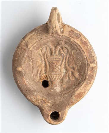 Roman Oil Lamp with Kantharos and Flowers, 1st - 2nd century AD; height cm 4,7, length cm 12,3