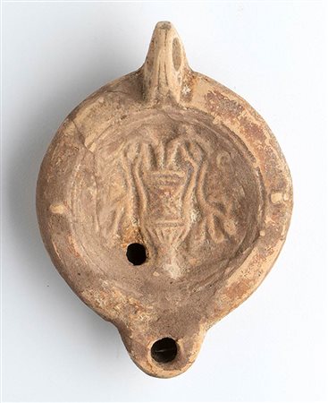 Roman Oil Lamp with Kantharos and Flowers, 1st - 2nd century AD; height cm 4,7, length cm 12,3