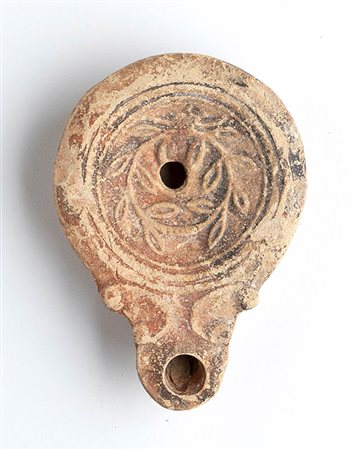 Roman Oil Lamp with Wreath, 1st - 2nd century AD; height cm 2,2, length cm 9
