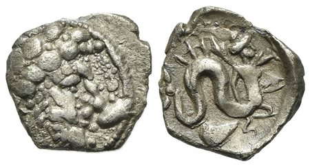 Campania, Allifae, Obol, ca. 325-275 BC. AR (0.58 g, mm 10; h 12). Laureate head of Apollo r.; [three dolphins] around; Rv. Skylla r., holding sepia and fish; mussel below. Campana 2a; HNItaly 460; SNG ANS 160-4. Rare, about very 