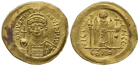 Justinian I (527-565); AV Solidus (g 4,47; mm 20,5; h 6); Constantinople, 545-565; Helmeted and cuirassed bust facing, holding globus cruciger and shield; Rv. Angel standing facing, holding staff terminating in Christogram and glo