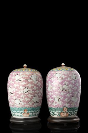 Due potiches in porcellana a fondo rosa decorate a motivo di gru tra nuvole, ba