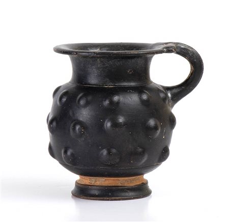 GREEK HELLENISTIC BLACK-GLAZED PINE CONE MOULDED JUG
South Italy, 4th century BC
