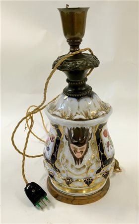 Manifattura del secolo XIX.
Lampada in porcellana decorata in policromia e dora