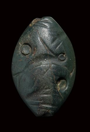 A minoan amygdaloid green jasper engraved seal.Fish with talismanic symbols .