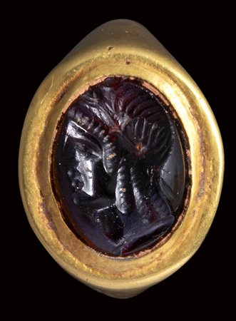 An fine hellenistic garnet intaglio mounted on an ancient gold ring. Bust of Isis. 