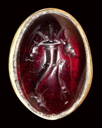 A ptolemaic garnet intaglio set in a gold ring. Cornucopia. 