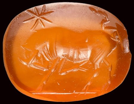 A roman carnelian intaglio. Bull with a star. 