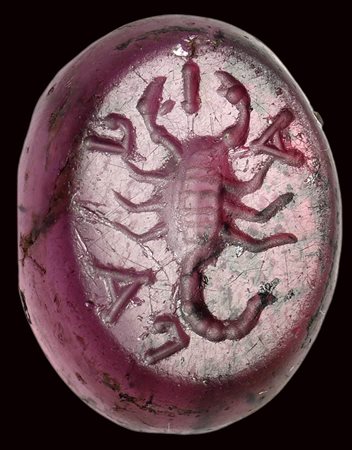 A roman republican garnet intaglio. Scorpio with letters. 