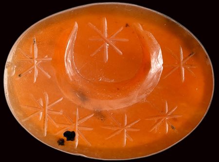 A large roman carnelian intaglio. Crescent moon with seven stars.