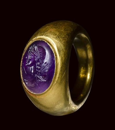 A roman amethyst intaglio set in a large  ancient gold ring. Bust of Artemis. 
