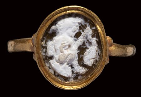 A roman burnt agate cameo mounted in a gold ring. Mythological scene. 
