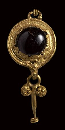 A roman gold and garnet earring with disc and pendant.