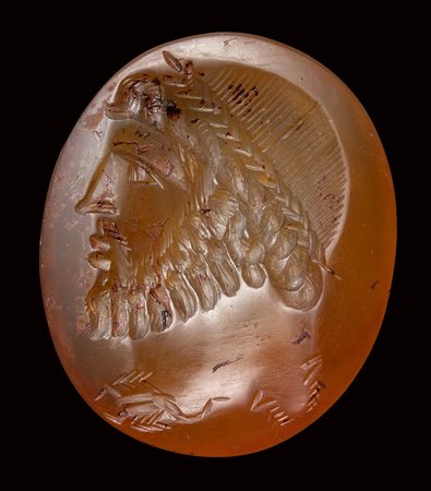 A large eastern roman carnelian  intaglio. Bearded male bust with astrological symbols.