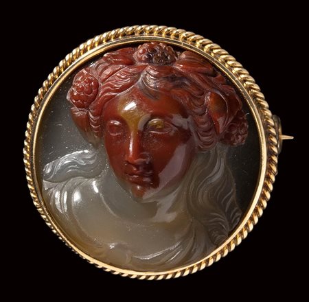 A fine neoclassical agate-chalcedony cameo mounted on a modern gold brooch. Bust of a Bacchante.